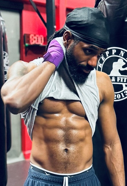 Coach CL in the gym with boxing wraps and heavy bags